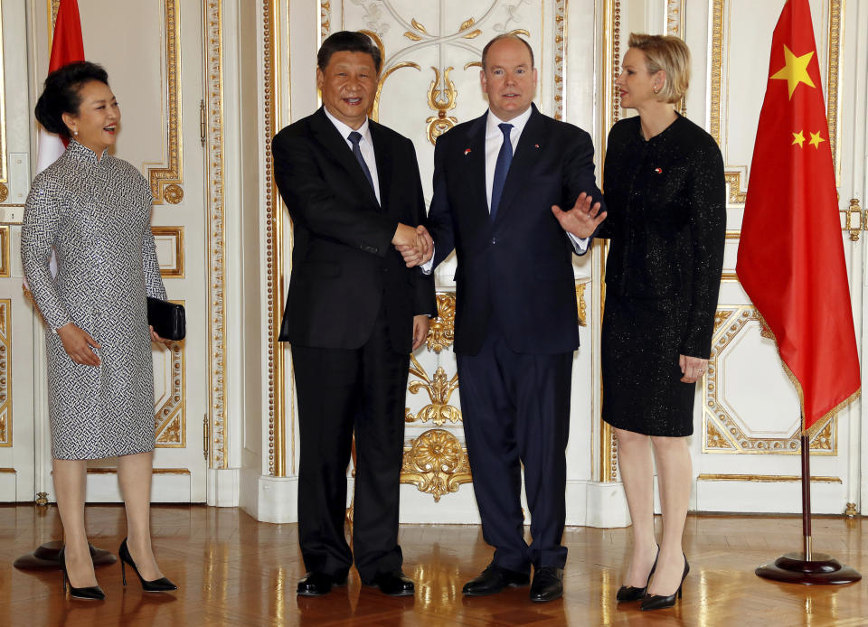 From left to right, The wife of Chinese President Xi Jinping, Chinese President Xi Jinping, Prince Albert II of Monaco and his wife Princess Charlene pose for photographers at Monaco Palace, Sunday, March 24, 2019. Xi is paying the first state visit by a Chinese president to the tiny Mediterranean principality of Monaco on Sunday. (Eric Gaillard/Pool Photo via AP)