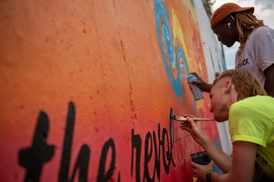 Branden Redmond and Vania Word collaborate on a mural for Color the Creek's Black Lives Matter project on Saturday, June 20, 2020 on the corner of Dickman Rd. and Riverside Dr. in Battle Creek, Mich. 