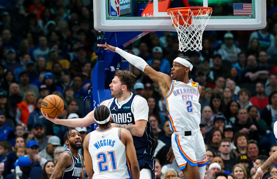 Feb 10, 2024; Dallas, Texas, USA; Dallas Mavericks guard Luka Doncic (77) scores over Oklahoma City Thunder guard Shai Gilgeous-Alexander (2) during the first half at American Airlines Center. Mandatory Credit: Kevin Jairaj-USA TODAY Sports