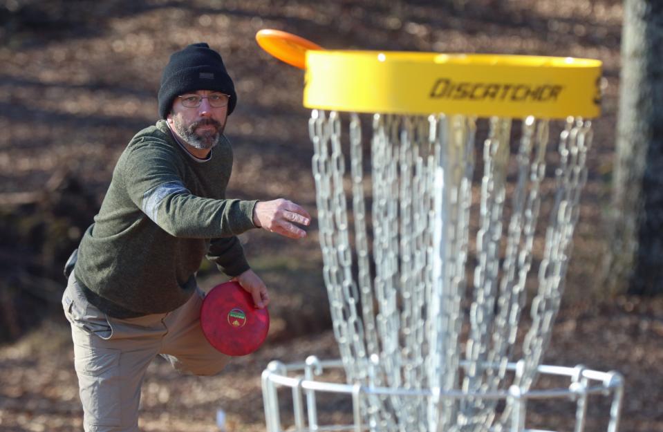 Dennis Martin competes in the first tournament held at Wolfman Disc Golf Club at Wolfman Woods on Artee Road in Lattimore early Saturday morning, Jan. 29, 2022.