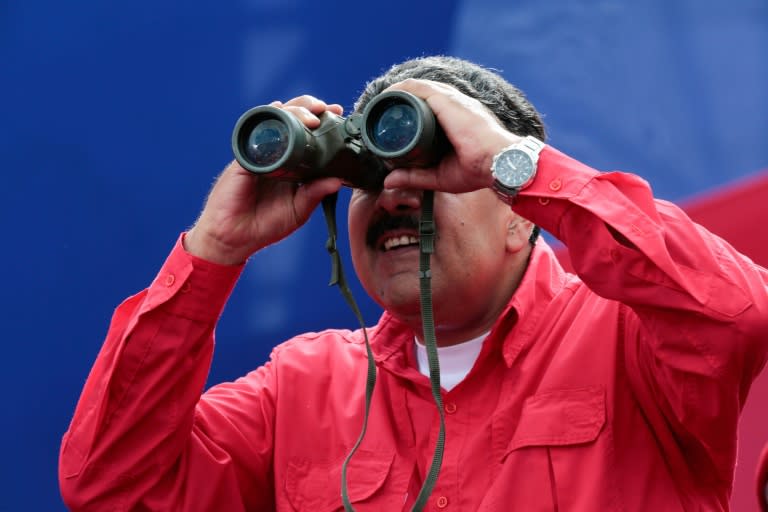 Venezuelan presidential office showing President Nicolas Maduro watching with binoculars during a rally in Caracas on April 19, 2017