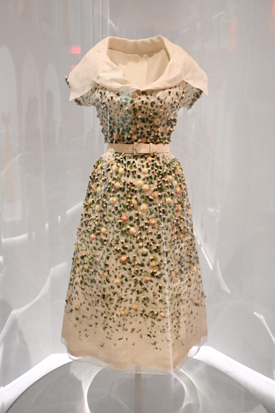 Vintage-style dress with floral embellishments on display