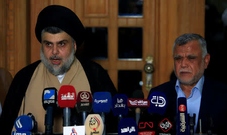 Iraqi Shi'ite cleric Moqtada al-Sadr speaks during a news conference with Leader of the Conquest Coalition and the Iran-backed Shi'ite militia Badr Organisation Hadi al-Amiri, in Najaf, Iraq June 12, 2018. REUTERS/Alaa al-Marjani/Files