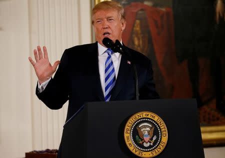 U.S. President Donald Trump talks about banning devices that can be attached to semiautomatic guns to make them automatic, during a Public Safety Medal of Valor Awards Ceremony at the White House in Washington, U.S., February 20, 2018. REUTERS/Leah Millis/Files