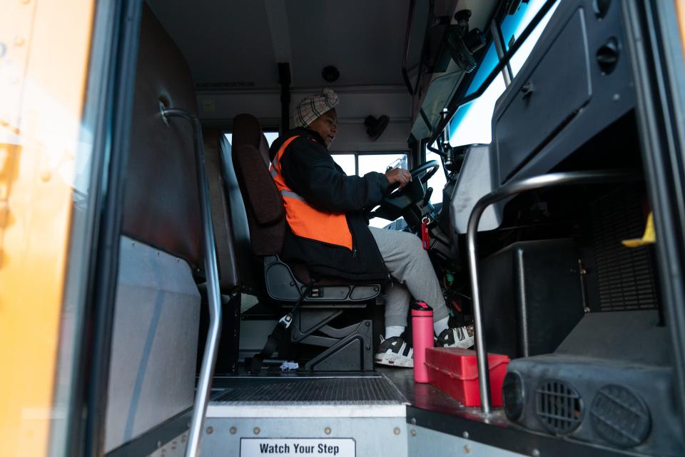 Mercedes Holford, a bus driver for Kansas Central Bus Service, checks over her equipment Wednesday morning prior to picking up students along her route.