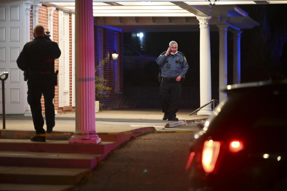 A St. Paul Police officer speaks on the phone outside of the Bradshaw Funeral Home Saturday, Nov. 28, 2020, after a man was shot multiple times by St. Paul Police in St. Paul, Minn. (Aaron Lavinsky/Star Tribune via AP)