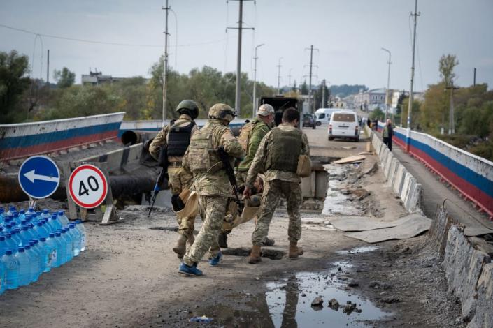 <div class="inline-image__title">1429122648</div> <div class="inline-image__caption"><p>Ukrainians soldiers carry a wounded comrade across a heavily damaged bridge over the Oskil River on September 30, 2022 in Kupiansk, Ukraine. Ukraine has recaptured thousands of square miles of its northeast Kharkiv region from Russian forces in recent weeks, and is continuing to pour armored vehicles, artillery and rocket systems into this front to recapture the region, while also pushing a separate offensive in the south to reclaim occupied Kherson and Crimea.</p></div> <div class="inline-image__credit">Scott Peterson/Getty Images</div>