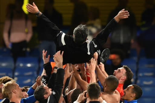 High life: Huddersfield Town coach David Wagner is thrown in the air by his players and staff