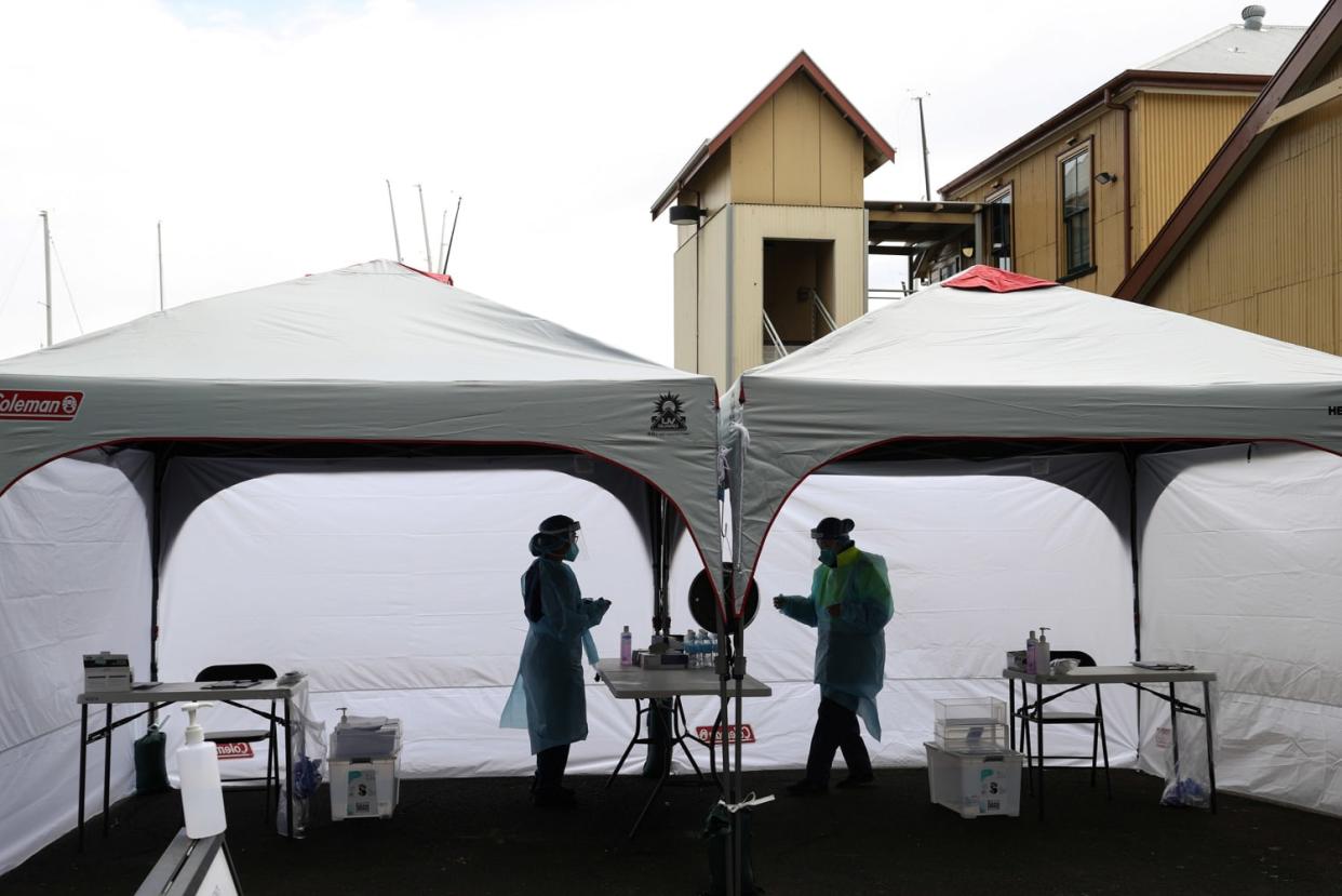 Image: Medical workers are seen at a COVID-19 pop-up testing centre in Sydney (Loren Elliott / Reuters)