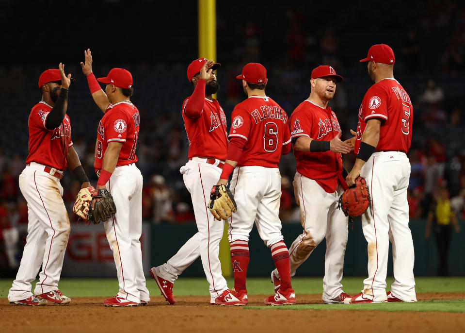 ANAHEIM, CALIFORNIA - AUGUST 14: (L-R) Luis Rengifo #4, Wilfredo Tovar #19, Brian Goodwin #18, David Fletcher #6, Kole Calhoun #56 and Albert Pujols #5 of the Los Angeles Angels celebrate after their MLB game against the Pittsburgh Pirates at Angel Stadium of Anaheim on August 14, 2019 in Anaheim, California. The Angels defeated the Pirates 7-4. (Photo by Victor Decolongon/Getty Images)