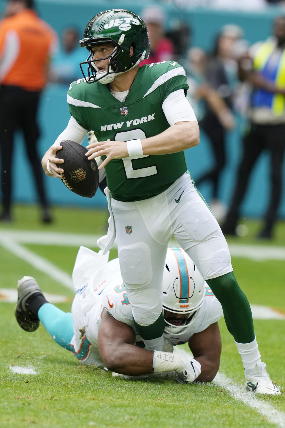 Miami Dolphins defensive tackle Christian Wilkins (94) grabs New York Jets quarterback Zach Wilson (2) during the first half of an NFL football game, Sunday, Dec. 17, 2023, in Miami Gardens, Fla. (AP Photo/Lynne Sladky)