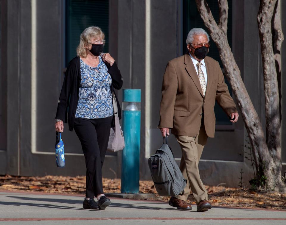 Ruben Flores, right, enters the Monterey County Courthouse, for trial in Salinas on July 18, 2022.