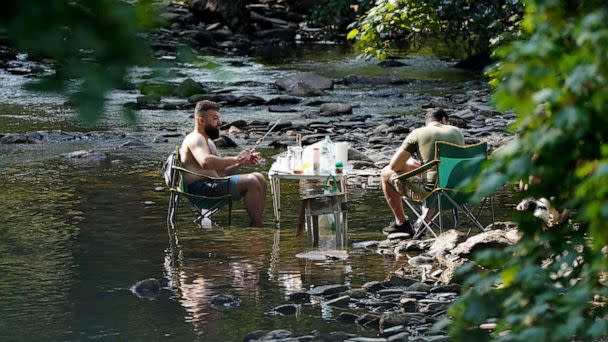 PHOTO: People escape the heat wave by having a barbecue in a river near the village of Luss in Argyll and Bute on the west bank of Loch Lomond, Scotland, July 18, 2022. (Andrew Milligan/AP)