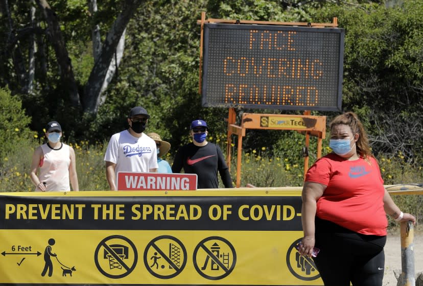 PASADENA, CA - MAY 24: Signs and volunteers reminded visitors to wear their masks at Eaton Canyon Natural Area Park on Sunday, May 24, 2020 in Pasadena, CA during the Memorial Day weekend. (Myung J. Chun / Los Angeles Times)