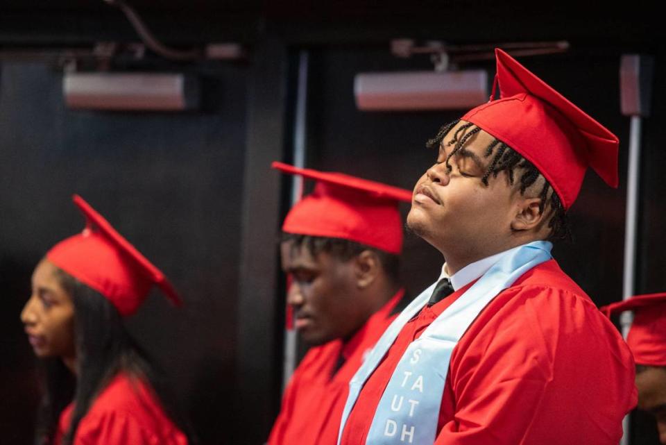 An Olympic High School graduate stands in line before walking to his seat prior to the ceremony at the Bojangles Coliseum in Charlotte on Monday, June 10, 2024.