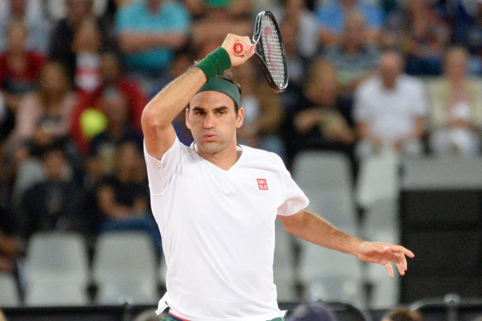 Switzerland's Roger Federer plays a return shot to Rafael Nadal.