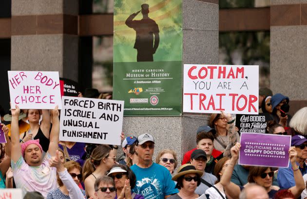 An abortion rights supporter&#39;s sign slams North Carolina state Rep. Tricia Cotham (R) as a 