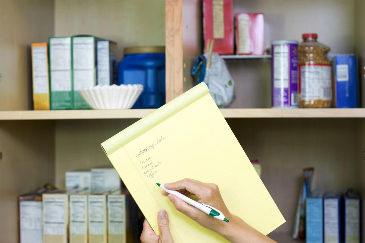 Making a list in front of the pantry