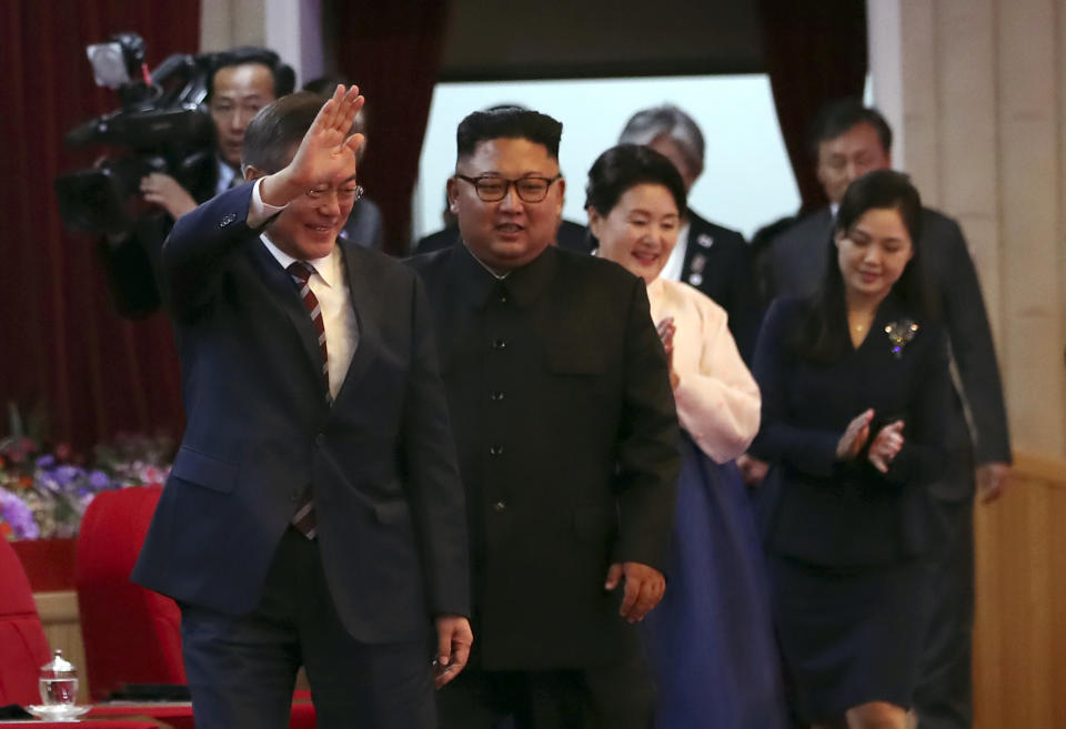South Korean President Moon Jae-in, left, his wife Kim Jung-sook, second from right, North Korean leader Kim Jong Un and his wife Ri Sol Ju, right, arrive at the Pyongyang Grand Theatre in Pyongyang, North Korea, Tuesday, Sept. 18, 2018. President Moon Jae-in began his third summit with North Korean leader Kim Jong Un on Tuesday with possibly his hardest mission to date — brokering some kind of compromise to keep North Korea's talks with Washington from imploding and pushing ahead with his own plans to expand economic cooperation and bring a stable peace to the Korean Peninsula. (Pyongyang Press Corps Pool via AP)