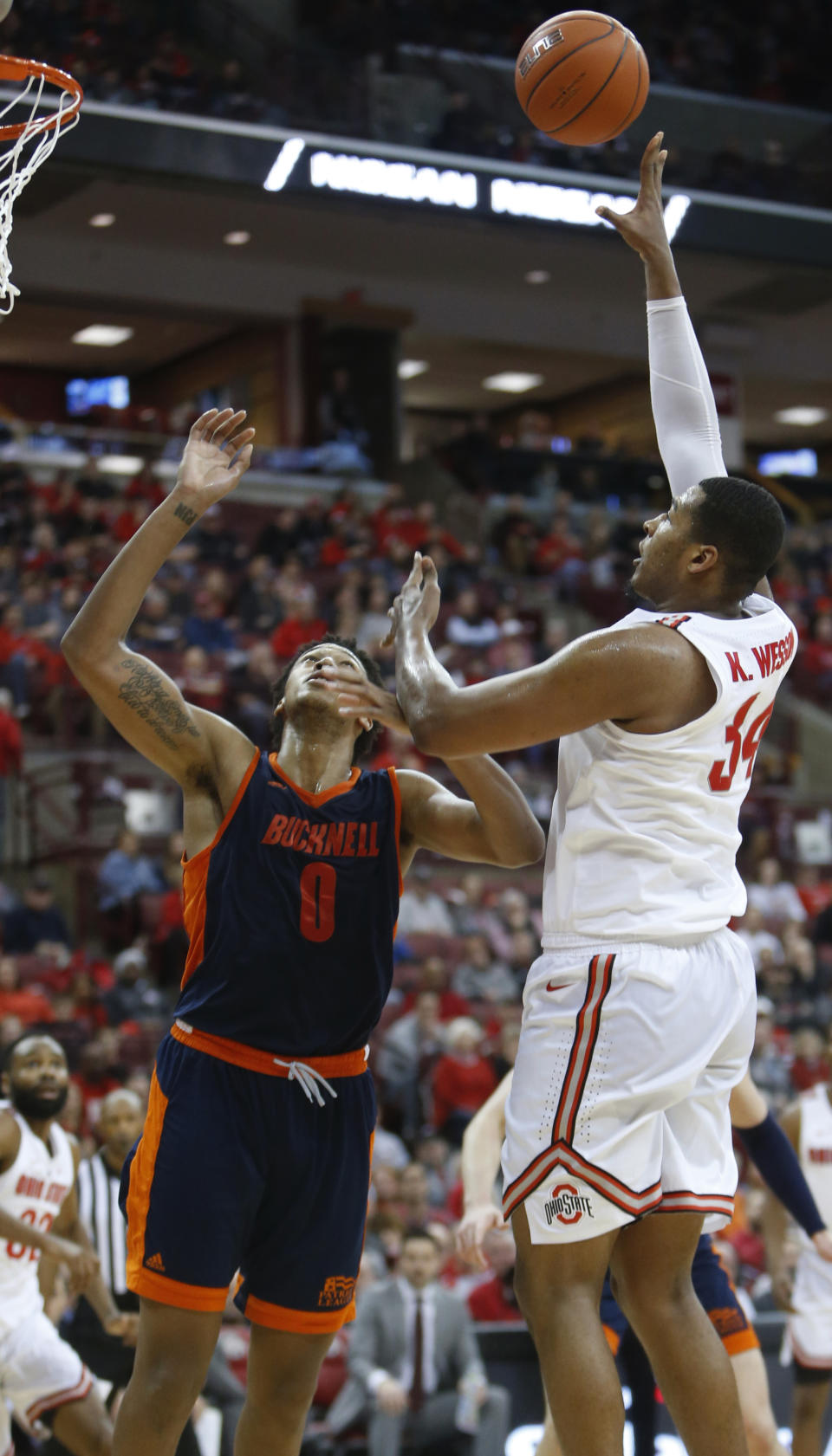 Ohio State's Kaleb Wesson, right, shoots over Bucknell's Paul Newman during the second half of an NCAA college basketball game Saturday, Dec. 15, 2018, in Columbus, Ohio. Ohio State beat Bucknell 73-71. (AP Photo/Jay LaPrete)