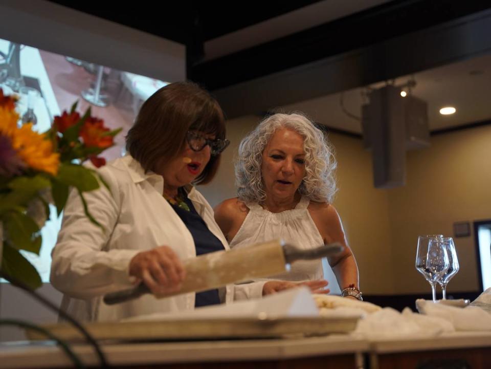 American Queen culinary ambassador Regina Charboneau shows passenger Lydia Gregory how to make the perfect biscuit.