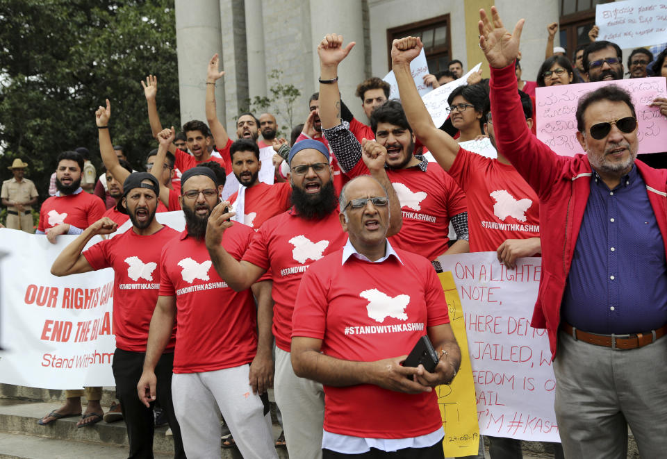 Kashmiris living in Bangalore shout slogans against the communication blockade in Indian controlled Kashmir during a protest in Bangalore, India, Saturday, Aug. 24, 2019. On Aug. 5, Prime Minister Narendra Modi's Hindu nationalist-led government revoked Muslim-majority Kashmir's decades-old special status guaranteed under Article 370 of India's Constitution and sent thousands of troops to the region, which is split between archrivals Pakistan and India and claimed by both in its entirety. (AP Photo/Aijaz Rahi)