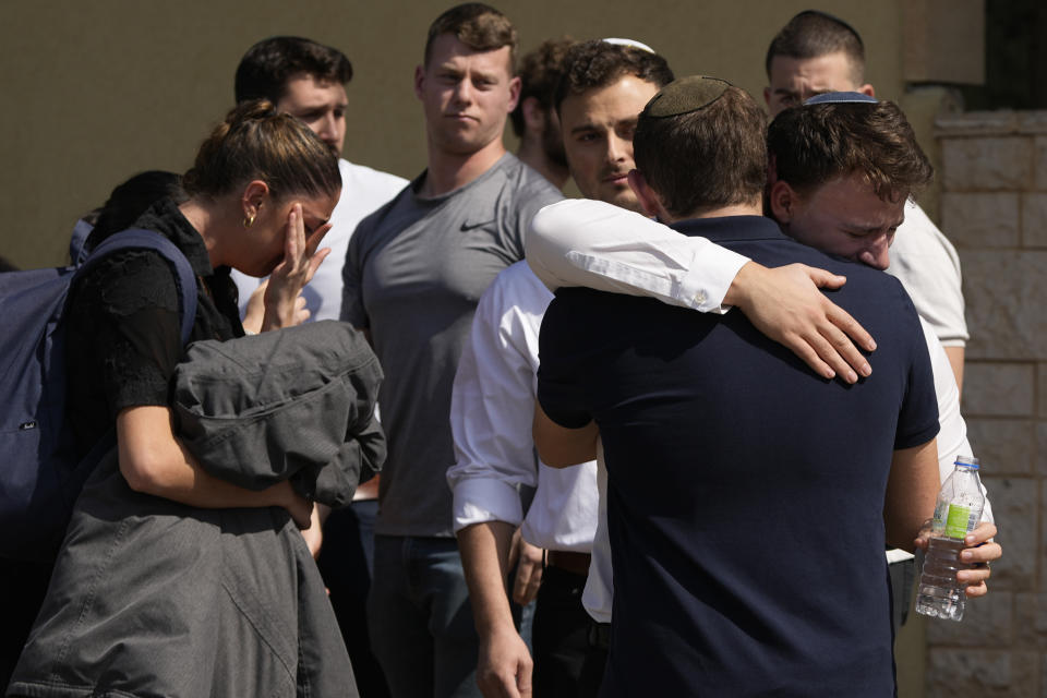 Mourners comfort each other at the funeral of Elan Ganeles, 27, a dual U.S.-Israeli citizen from West Hartford, Connecticut, in Raanana, Israel, Wednesday, March 1, 2023. The Israeli army said a suspected Palestinian gunman opened fire on Tuesday at an Israeli car near the Palestinian city of Jericho, hitting killing Ganeles. A friend told local media he had been visiting Israel for a wedding and driving on a highway near the Dead Sea when he was shot. (AP Photo/Tsafrir Abayov)