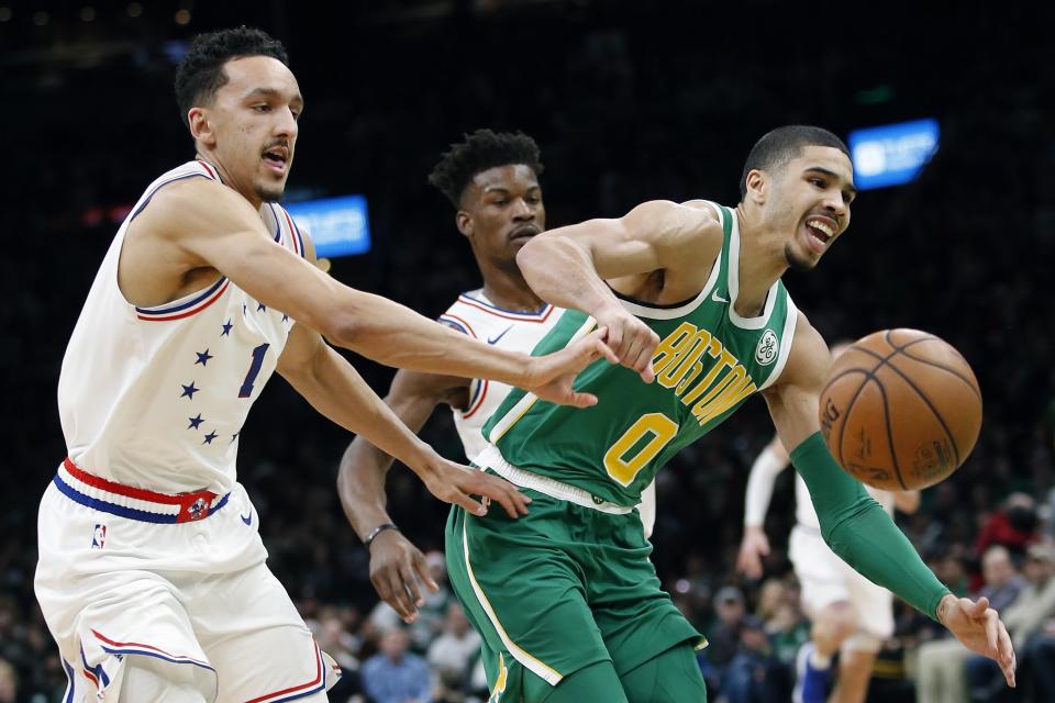 Boston Celtics' Jayson Tatum (0) and Philadelphia 76ers' Landry Shamet (1) can't come up with a loose ball during the first half of an NBA basketball game in Boston, Tuesday, Dec. 25, 2018. (AP Photo/Michael Dwyer)