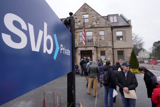 Customers and bystanders form a line outside a Silicon Valley Bank branch location on March 13. The bank's failure sent shock waves throughout the U.S. and global banking systems.