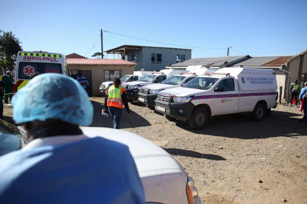 PHOTO: Mortuary vans are seen as forensic personnel load bodies of victims after the deaths of patrons found inside the Enyobeni Tavern, in Scenery Park, outside East London in the Eastern Cape province, South Africa, June 26, 2022. (Stringer/Reuters)