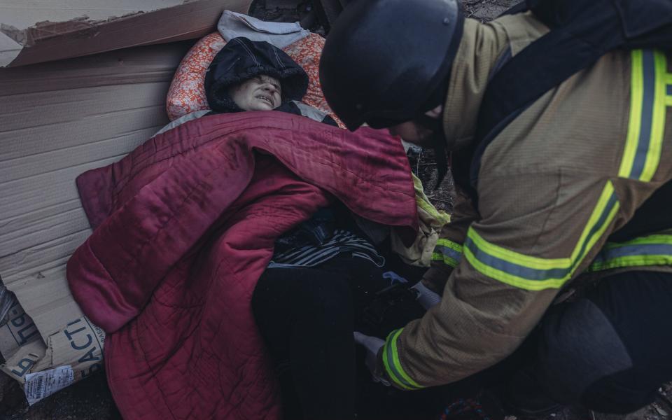 Emergency workers treat a civilian injured by shrapnel after Russian shelling in Bakhmut, Donetsk region - Anadolu Agency via Getty Images