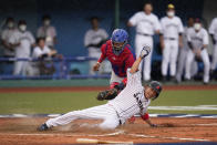 Japan's Tetsuto Yamada, bottom, is tagged out by Dominican Republic catcher Charlie Valerio while trying to score on a double hit by Masataka Yoshida in the eighth inning of a baseball game at the 2020 Summer Olympics, Wednesday, July 28, 2021, in Fukushima, Japan. (AP Photo/Jae C. Hong)