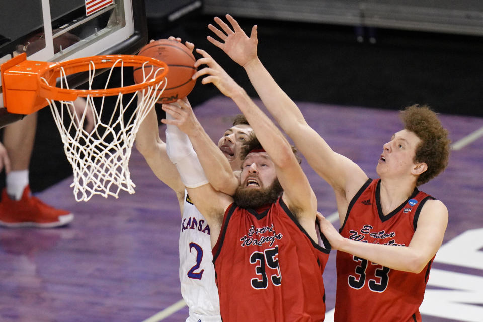 Kansas guard Christian Braun (2) Eastern Washington forward Tanner Groves (35) and Jacob Groves (33) battle for a rebound during the second half of a first-round game in the NCAA college basketball tournament at Farmers Coliseum in Indianapolis, Saturday, March 20, 2021. (AP Photo/AJ Mast)