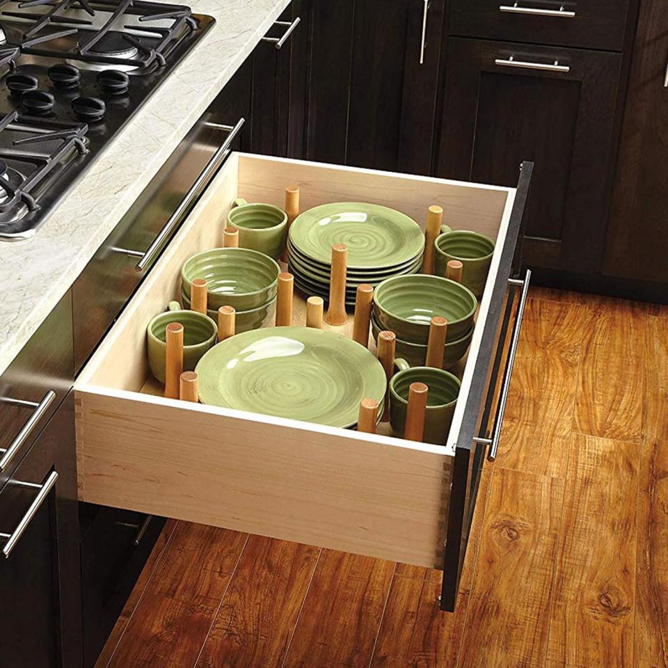 a kitchen drawer with pegboard organizer