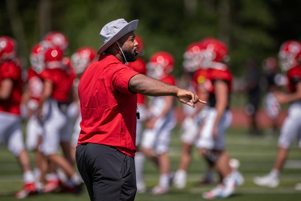 New St. John's football coach John Vassar calls out during drills before playing Brockton in a scrimmage last month.