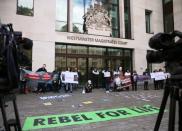 Demonstrators protest outside of Westminster Magistrates Court, where a case hearing for U.S. extradition of Wikileaks founder Julian Assange is held, in London