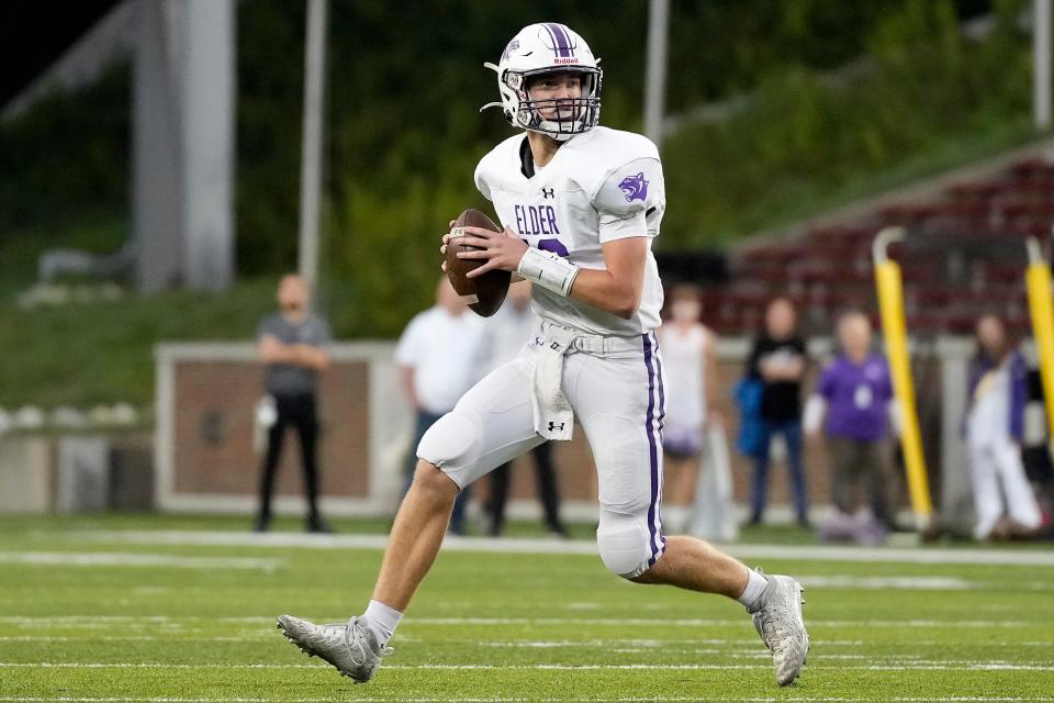 Elder quarterback Ben Schoster (16) scrambles to throw in the first quarter of the game between the Elder High School Panthers and the Moeller High School Crusaders at Nippert Stadium in Cincinnati on Friday, Sept. 30, 2022. Moeller took a decisive 42-14 victory over Elder. 