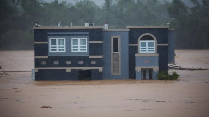 A home is submerged in floodwaters caused by Hurricane Fiona in Cayey, Puerto Rico on Sunday. According to authorities three people were inside the home and were reported to have been rescued. (Photo: Stephanie Rojas/AP)