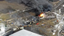 This photo taken with a drone shows portions of a Norfolk and Southern freight train that derailed Friday night in East Palestine, Ohio are still on fire at mid-day Saturday, Feb. 4, 2023. (AP Photo/Gene J. Puskar)