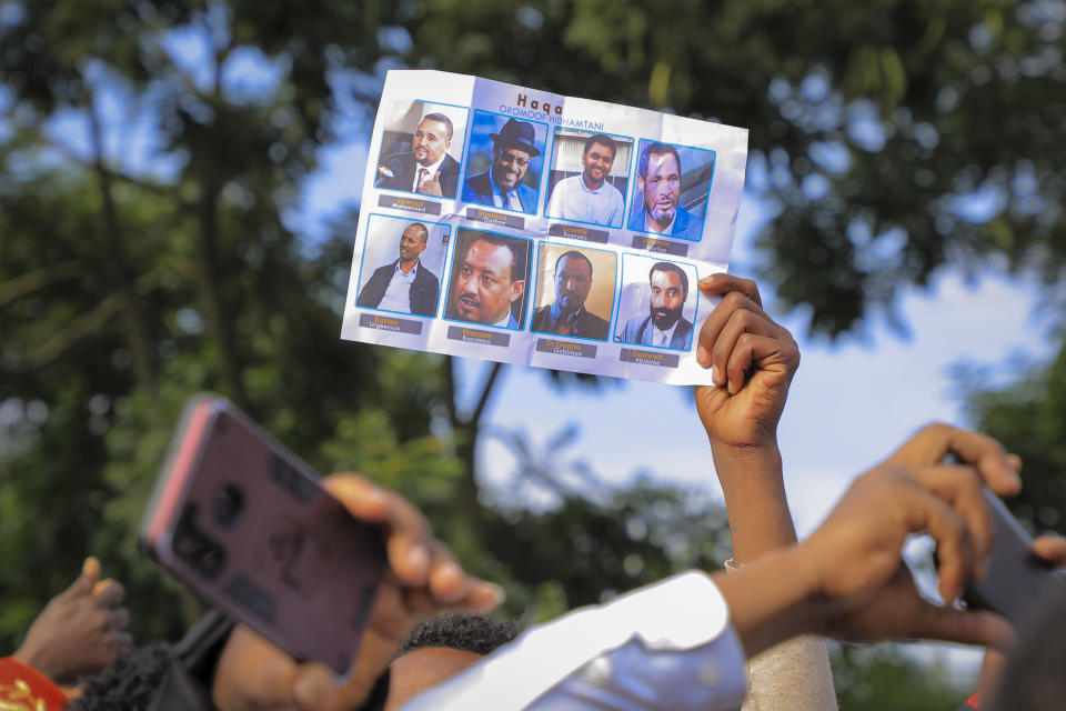 Oromos protest against the government and call for the release of prominent opposition figure Jawar Mohammed and others, seen on placards, during the annual Irreecha festival in the capital Addis Ababa, Ethiopia, Saturday, Oct. 2, 2021. Ethiopia's largest ethnic group, the Oromo, on Saturday celebrated the annual Thanksgiving festival of Irreecha, marking the end of winter where people thank God for the blessings of the past year and wish prosperity for the coming year. Placard in Oromo reads "Right. Arrested for Oromo truth". (AP Photo)