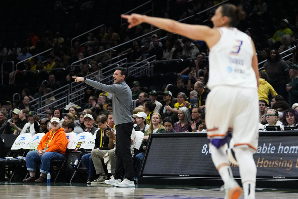 Phoenix Mercury coach Nate Tibbetts, left, points as guard Diana Taurasi, right, does the same during the first half of the team's WNBA basketball game against the Seattle Storm, Tuesday, June 4, 2024, in Seattle. (AP Photo/Lindsey Wasson)