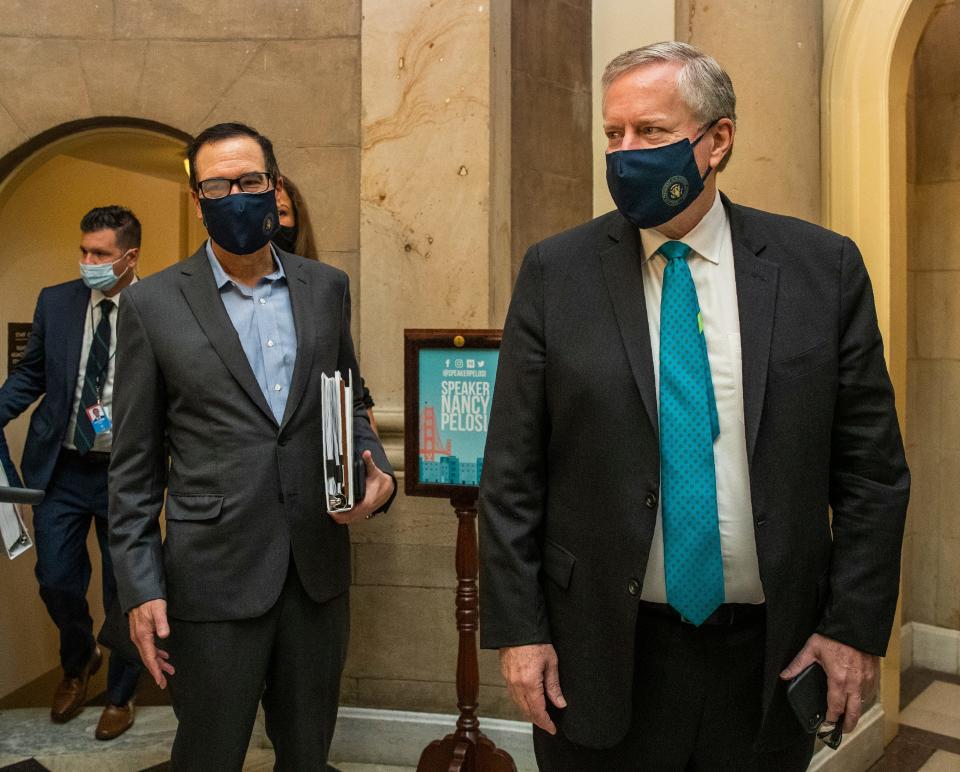 White House chief of staff Mark Meadows, right, and Treasury Secretary Steven Mnuchin, arrive at the office of House Speaker Nancy Pelosi at the Capitol to resume talks on a COVID-19 relief bill on Saturday.