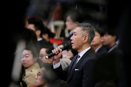 Reuters Beijing Bureau Chief Ryan Woo asks a question at a news conference by Chinese Premier Li Keqiang following the closing session of the National People's Congress (NPC) at the Great Hall of the People in Beijing, China March 15, 2019. REUTERS/Jason Lee