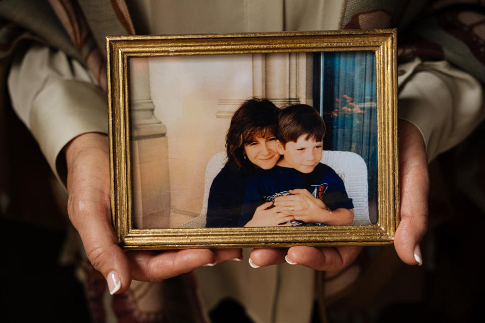 Linda Clary holds a family photo of both herself and her son John Umberger. (Will Crooks for NBC News)