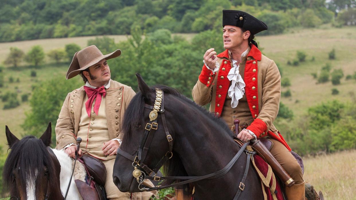 Luke Evans stars as Gaston and Josh Gad as Le Fou