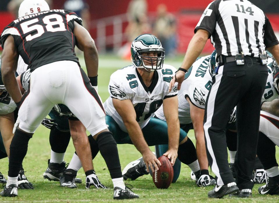 In this Sept. 23, 2012, file photo, Philadelphia Eagles long snapper Jon Dorenbos (46) waits to snap the ball as Arizona Cardinals' Daryl Washington (58) and umpire Randy Tabler look on during the second half of an NFL football gamein Glendale, Ariz.