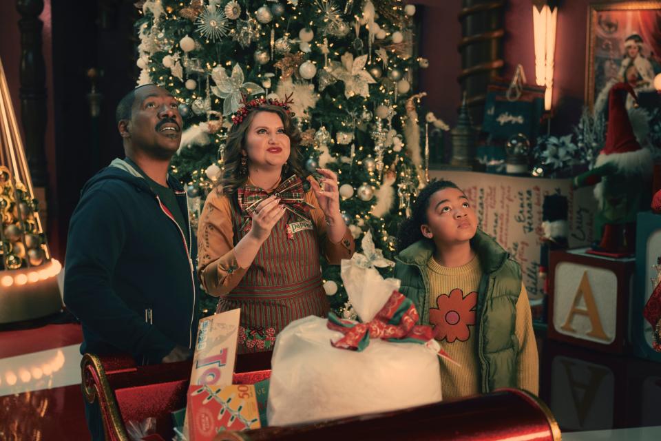 Chris Carver (Eddie Murphy), with his daughter Holly Carver (Madison Thomas), makes a stop at a mysterious holiday shop owned by suspicious elf Pepper (Jillian Bell) in "Candy Cane Lane."