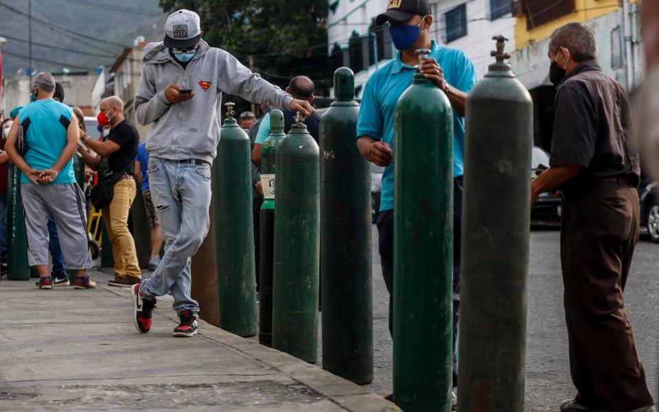 Brazilians queue to refill oxygen cylinders to be used by coronavirus patients in Caracas - Pedro Rances Mattey/AFP via Getty