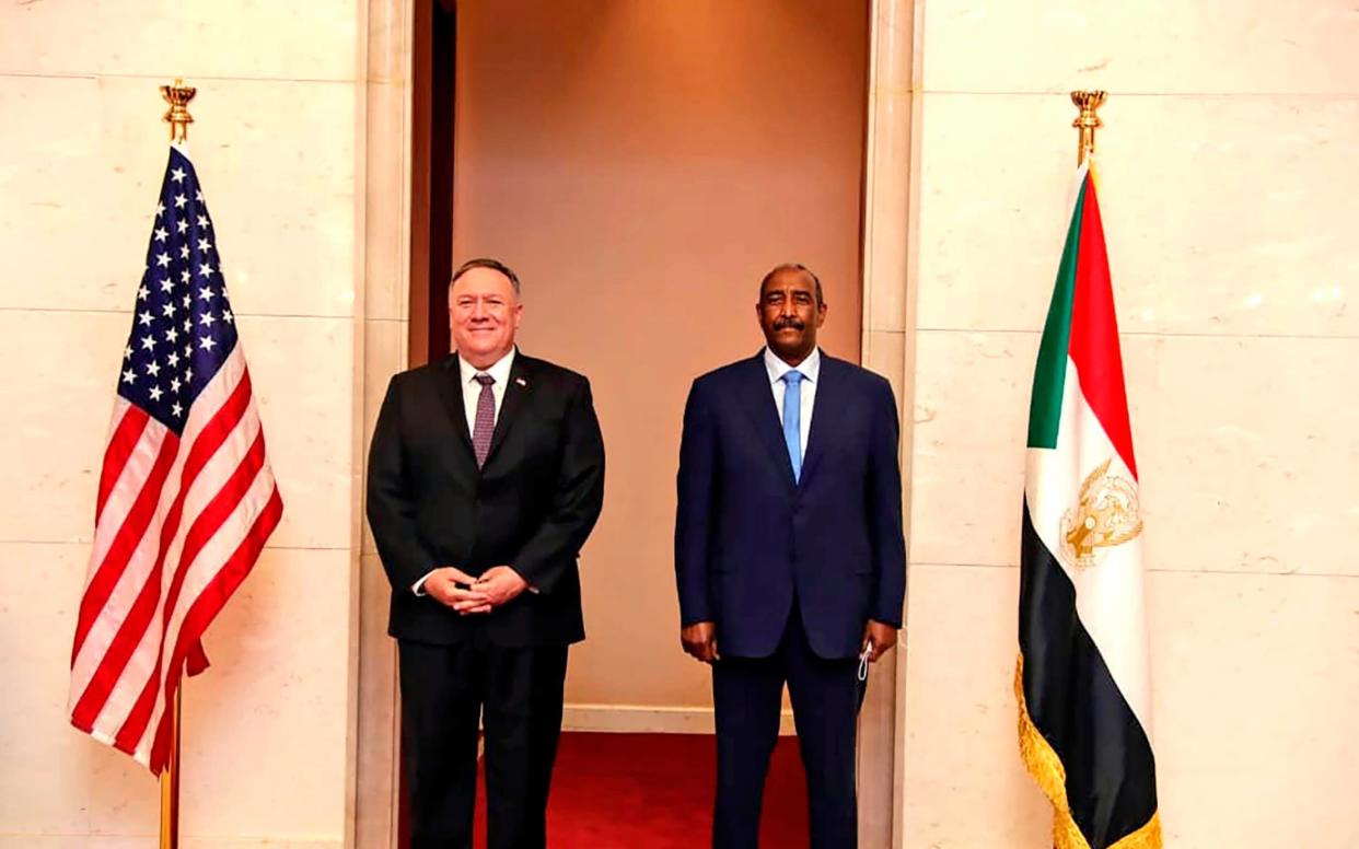 U.S. Secretary of State Mike Pompeo stands with Sudanese Gen. Abdel-Fattah Burhan, the head of the ruling sovereign council, in Khartoum - Sudanese Cabinet /Sudanese Cabinet 