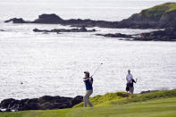 Andrew Putnam follows his approach shot to the ninth green of the Pebble Beach Golf Links during the third round of the AT&T Pebble Beach Pro-Am golf tournament in Pebble Beach, Calif., Saturday, Feb. 5, 2022. (AP Photo/Eric Risberg)